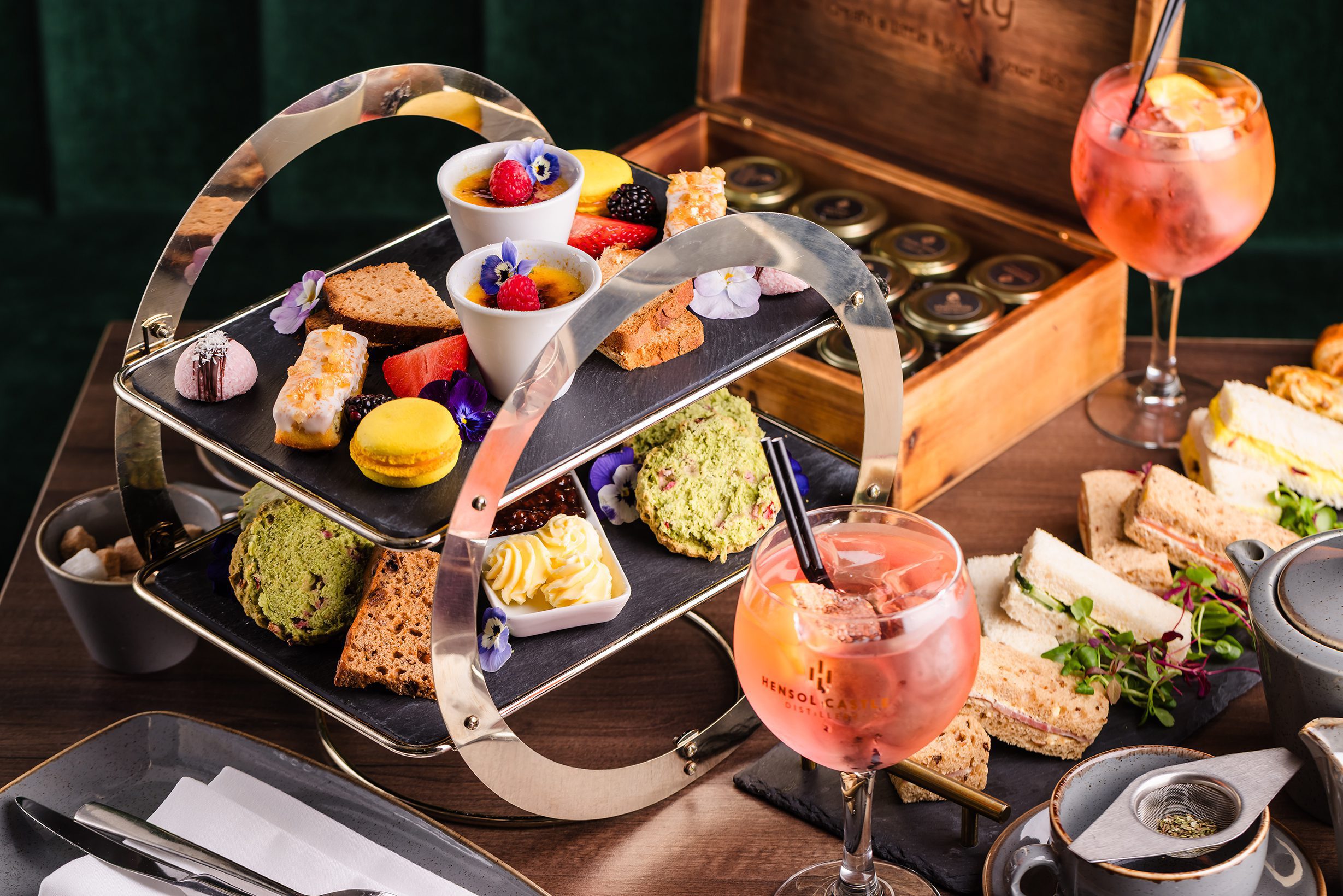 A tiered tray with pastries, cakes, and sandwiches—perfect for relaxing hotel breaks in South Wales.